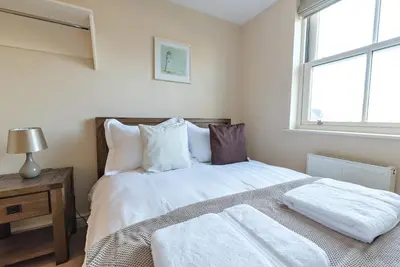 a bedroom with a bed with two towels on it at Camstay New Street in Cambridge
