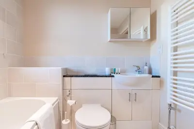 a bathroom with a white toilet and a sink at Camstay New Street in Cambridge