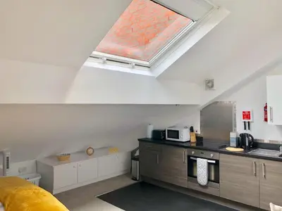 a kitchen with a skylight in the ceiling of a room at Toothbrush Apartments - Ipswich Central East in Ipswich