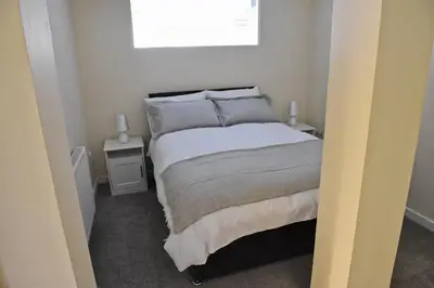 a bedroom with a bed and a window at Toothbrush Apartments - Ipswich Central East in Ipswich