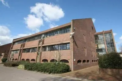 a large brick building with windows on the side of it at Toothbrush Apartments - Ipswich Central East in Ipswich