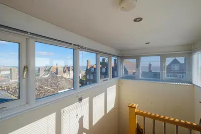 a balcony with windows and a view of the city at Seascape in Aldeburgh