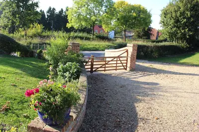 a garden with flowers and a wooden fence at Oakwrights in Terling
