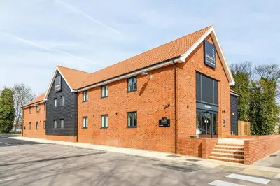 a red brick building with a black roof at Mermaid, Ipswich by Marston's Inns in Ipswich