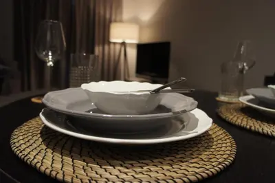 a bowl on a plate on a table at Great Northern Road Apartment in Cambridge