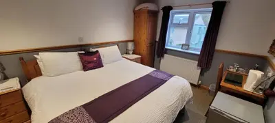 a bedroom with a large bed and a window at Alington House in Cambridge