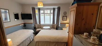 a small room with two beds and a bathroom at Alington House in Cambridge