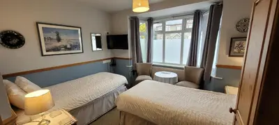 a hotel room with two beds and a window at Alington House in Cambridge