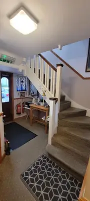 a living room with a staircase and a stair case at Alington House in Cambridge