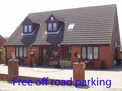 a red brick house with a free off road parking at Finjaro in Sproughton