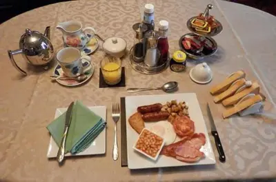 a table with a plate of breakfast food on it at Finjaro in Sproughton