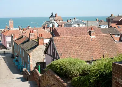 a city with roofs and the ocean in the background at Little Chequers in Friston
