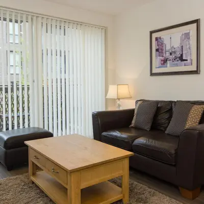 a living room with a couch and a coffee table at Citystay Living - Mill Park Apartments in Cambridge