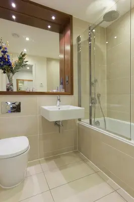 a bathroom with a toilet and a sink and a shower at Citystay Living - Mill Park Apartments in Cambridge