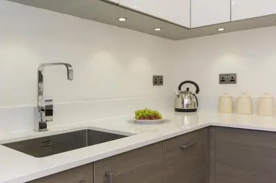 a kitchen with a sink and a mixer at Citystay Living - Mill Park Apartments in Cambridge