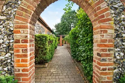 an archway in a brick wall with a pathway at Sturmer Hall Hotel and Conference Centre in Haverhill