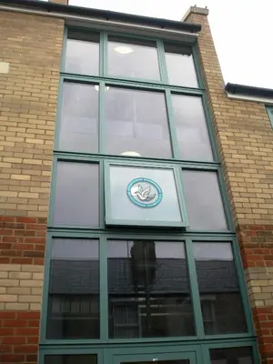 a building with a sign in the middle of a window at Citystay Living - Dove House in Cambridge