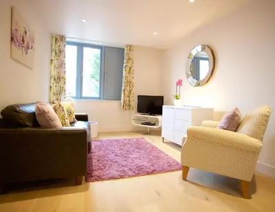 a living room with a couch and a tv at Citystay Living - Pringle House in Cambridge