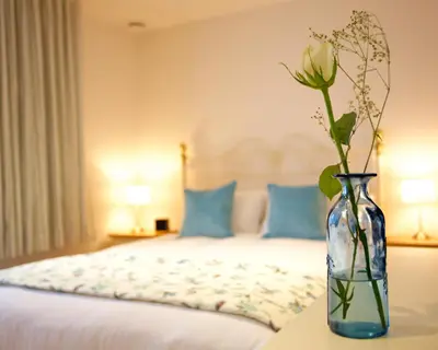 a vase with a flower on a table in a bedroom at Citystay Living - Pringle House in Cambridge
