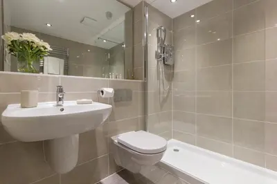 a bathroom with a sink and a toilet and a shower at Citystay Living - The Dales in Cambridge