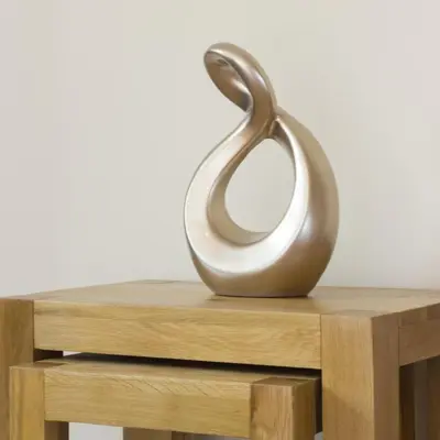 a metal sculpture sitting on top of a wooden table at Citystay Living - Citygate in Cambridge