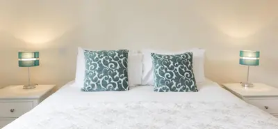 a bedroom with a white bed with two lamps at Citystay Living - Citygate in Cambridge