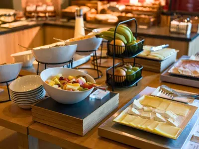 a table with a bowl of fruit and other food at B&B HOTEL Ipswich in Ipswich