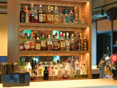 a cabinet filled with lots of bottles of alcohol at B&B HOTEL Ipswich in Ipswich