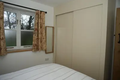 a bedroom with a bed and a window at The Elms Annex in Cottered