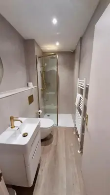 a bathroom with a toilet and a sink and a shower at Hotel Coco in Felixstowe