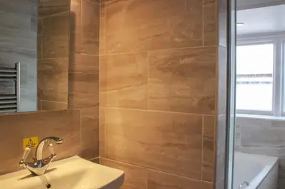 a bathroom with a sink and a shower at Hotel Coco in Felixstowe