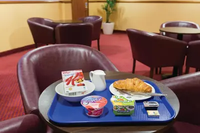 a table with a tray of food on it at Days Inn Stevenage North in Baldock