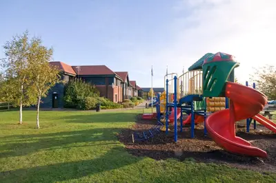 a playground with a slide in a park at Days Inn Stevenage North in Baldock