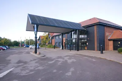 a gas station with a solar roof on a street at Days Inn Stevenage North in Baldock