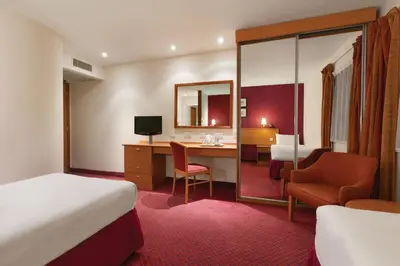 a hotel room with a bed and a desk at Days Inn Stevenage North in Baldock