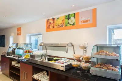 a buffet line with pastries and other food items at Holiday Inn Express Braintree by IHG in Braintree