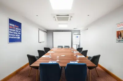 a large conference room with a long table and chairs at Holiday Inn Express Braintree by IHG in Braintree