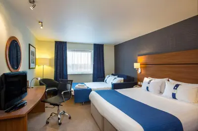 a hotel room with a bed and a desk and a tv at Holiday Inn Express Braintree by IHG in Braintree