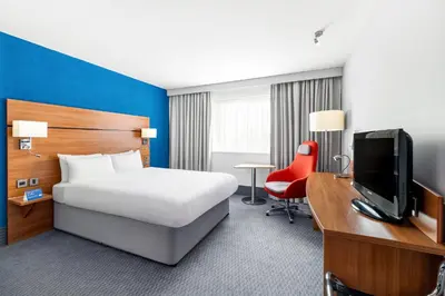a hotel room with a bed and a desk and a tv at Holiday Inn Express Braintree by IHG in Braintree