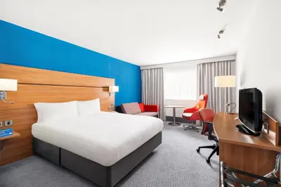 a hotel room with a bed and a desk and a tv at Holiday Inn Express Braintree by IHG in Braintree