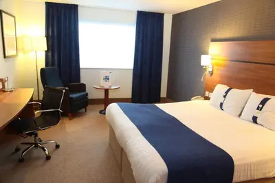 a hotel room with a bed and a desk and a window at Holiday Inn Express Braintree by IHG in Braintree