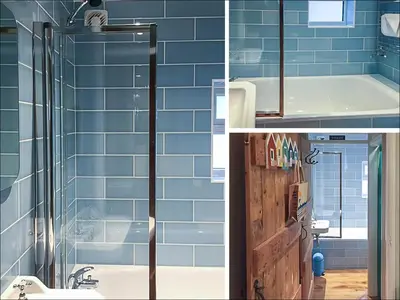 a bathroom with blue tiles and a tub and a shower at Ivy Cottage in Aldeburgh