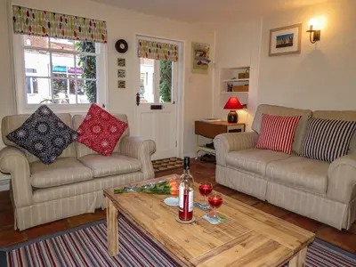 a living room with two couches and a coffee table at Ivy Cottage in Aldeburgh