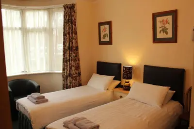 a bedroom with two beds and a window at Lantern House in Cambridge