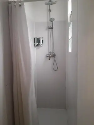 a shower with a shower curtain in a bathroom at Lantern House in Cambridge
