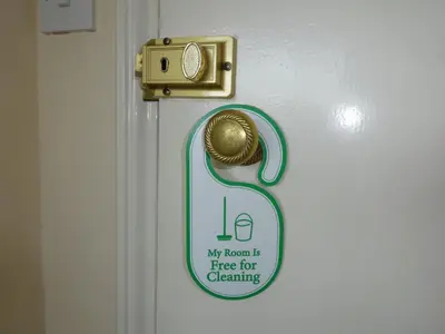 a sign on a door with a gold door knob at Lantern House in Cambridge