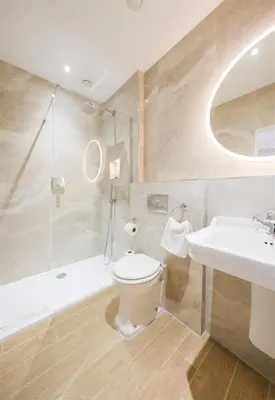 a bathroom with a toilet and a sink and a tub at Mulberry House in Ongar
