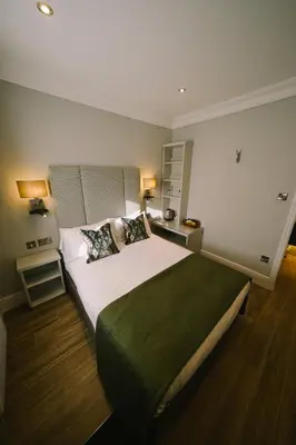 a bedroom with a large bed with two pillows at Mulberry House in Ongar
