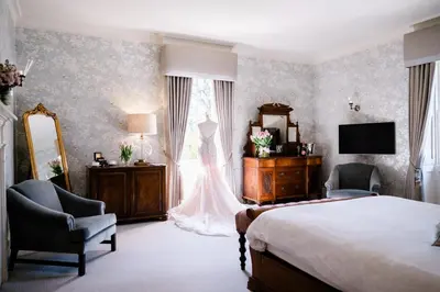 a bedroom with a bed and a dresser and a mirror at Mulberry House in Ongar