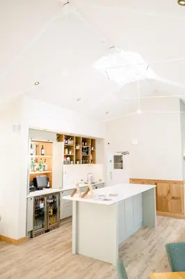 an open kitchen with a white island in a room at Mulberry House in Ongar